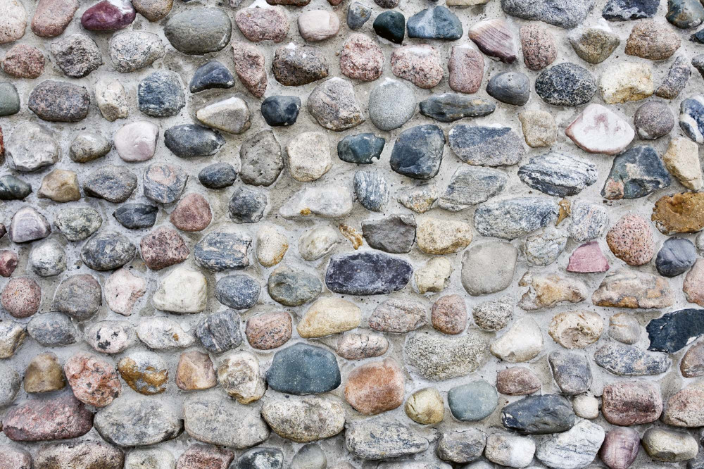 Vlies Fotótapéta - A stacked stone wall - 375x250 cm